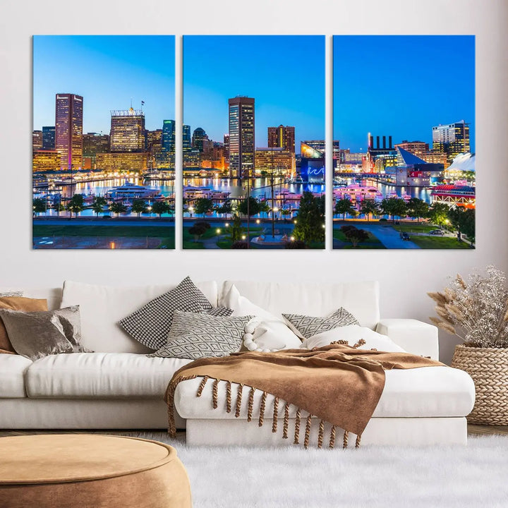 The Baltimore City Lights Blue Skyline Cityscape View Wall Art Canvas Print, a three-panel depiction of a city skyline at dusk on museum-quality canvas, adorns the area, showcasing an elegant evening cityscape.