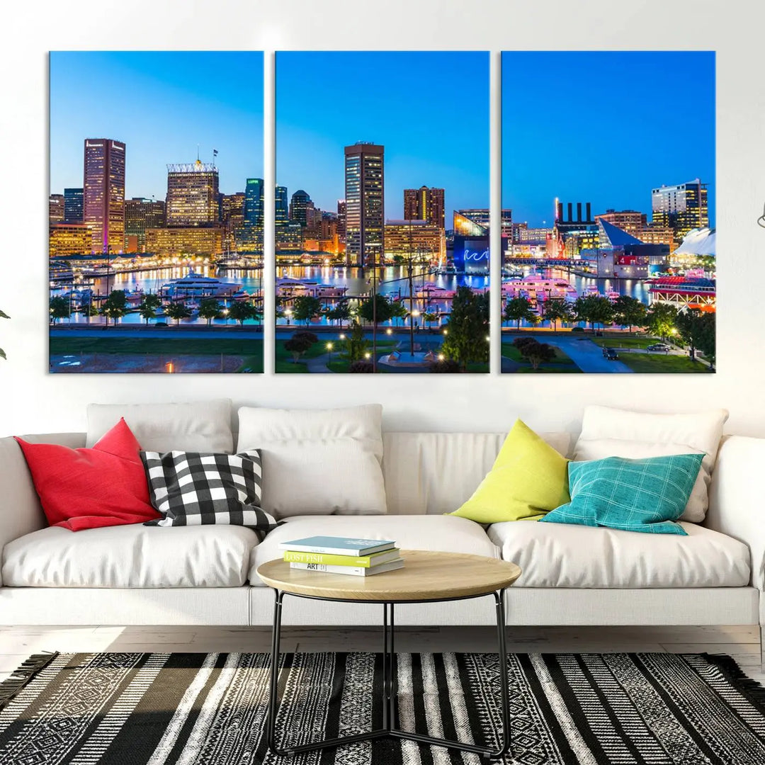 The Baltimore City Lights Blue Skyline Cityscape View Wall Art Canvas Print, a three-panel depiction of a city skyline at dusk on museum-quality canvas, adorns the area, showcasing an elegant evening cityscape.