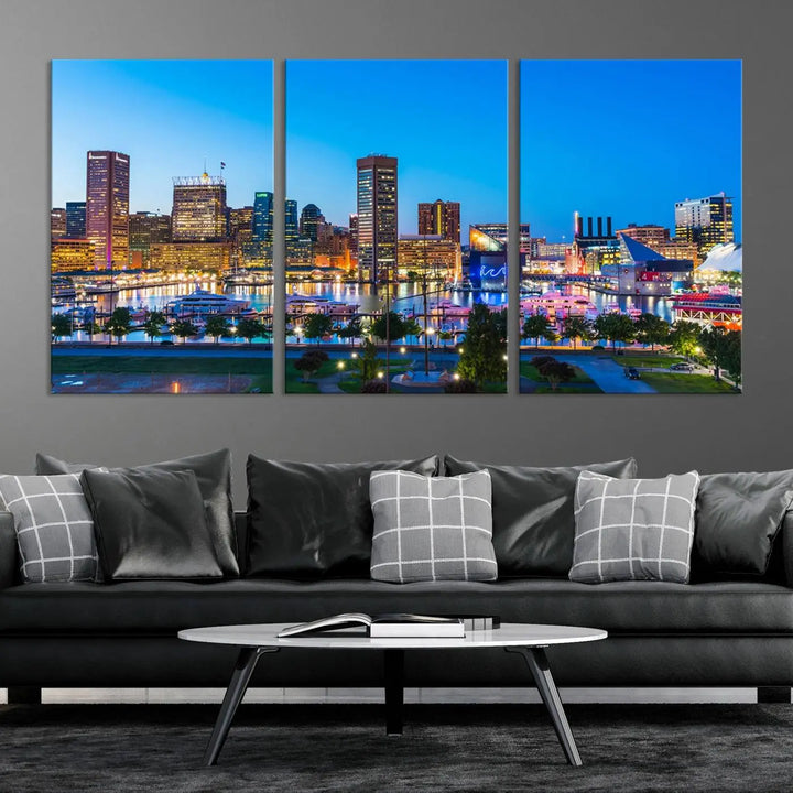 The Baltimore City Lights Blue Skyline Cityscape View Wall Art Canvas Print, a three-panel depiction of a city skyline at dusk on museum-quality canvas, adorns the area, showcasing an elegant evening cityscape.