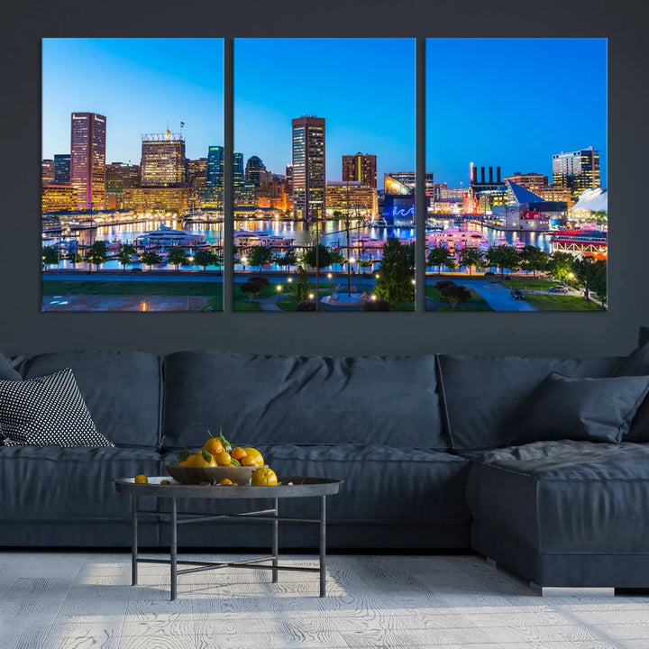 The Baltimore City Lights Blue Skyline Cityscape View Wall Art Canvas Print, a three-panel depiction of a city skyline at dusk on museum-quality canvas, adorns the area, showcasing an elegant evening cityscape.