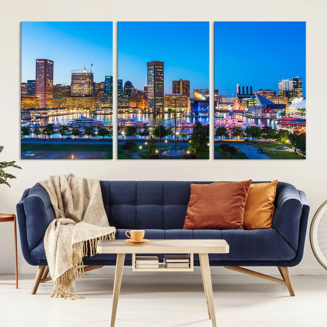 The Baltimore City Lights Blue Skyline Cityscape View Wall Art Canvas Print, a three-panel depiction of a city skyline at dusk on museum-quality canvas, adorns the area, showcasing an elegant evening cityscape.