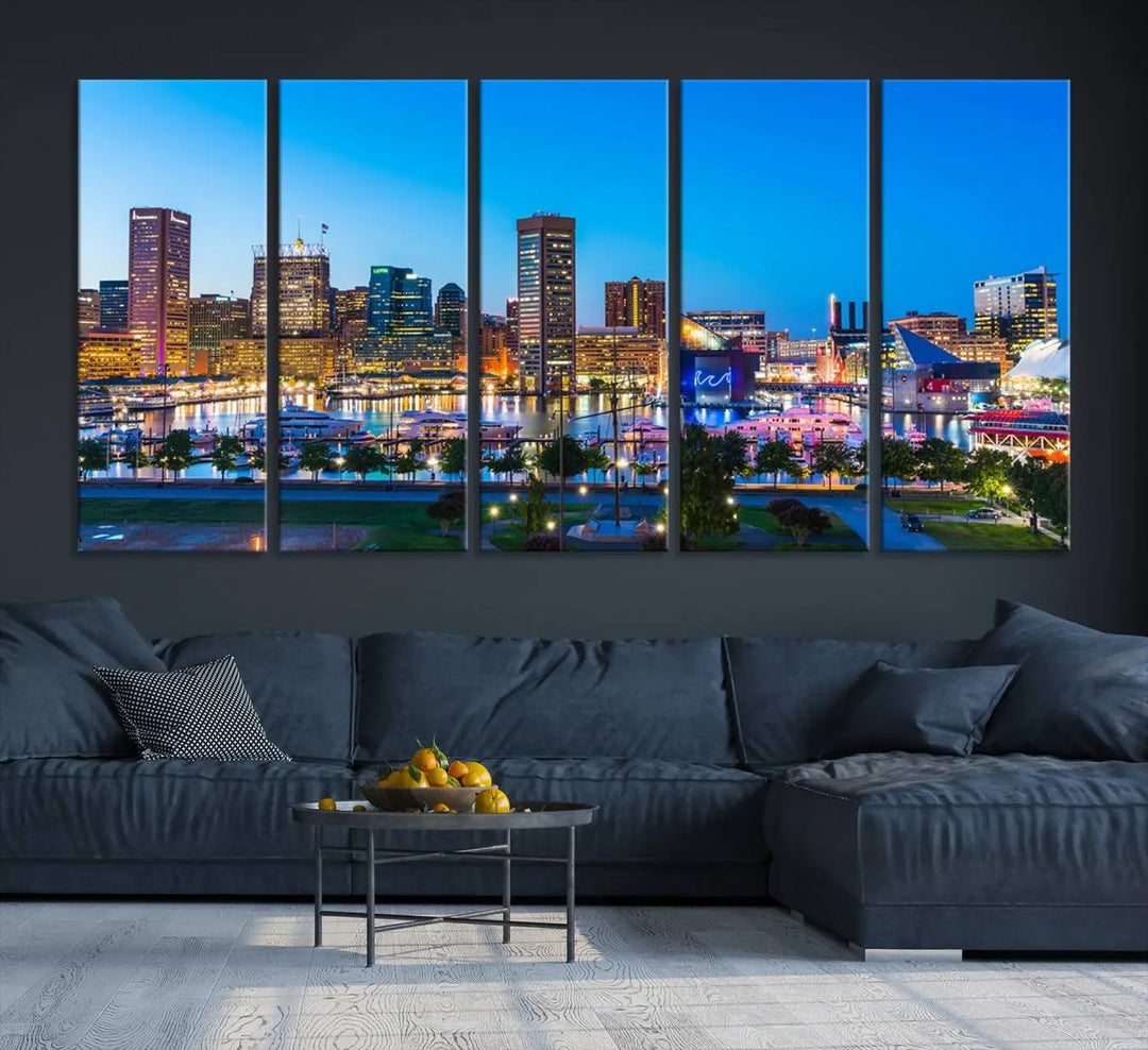 The Baltimore City Lights Blue Skyline Cityscape View Wall Art Canvas Print, a three-panel depiction of a city skyline at dusk on museum-quality canvas, adorns the area, showcasing an elegant evening cityscape.