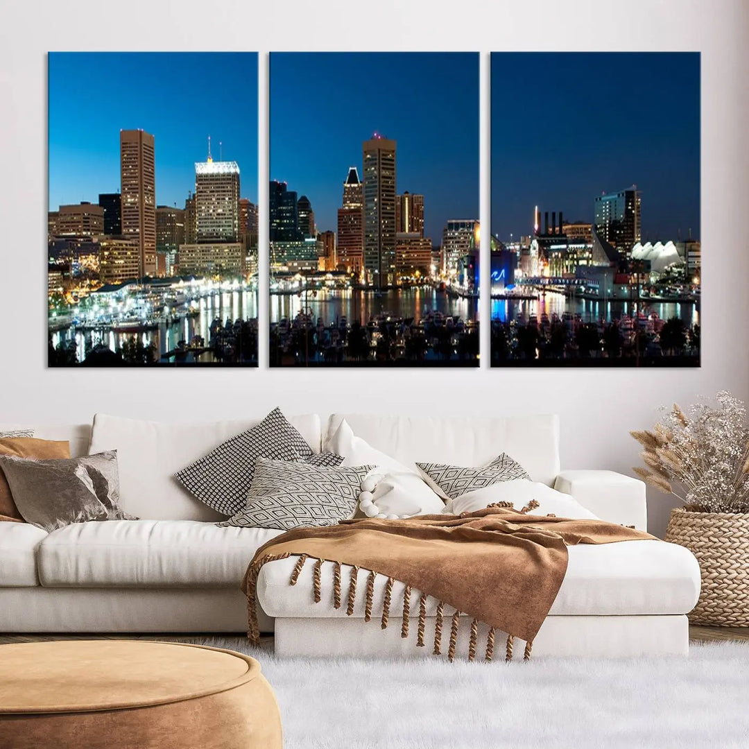 The Baltimore City Lights Night Blue Skyline Wall Art Canvas Print, professionally hand-assembled and ready to hang, graces the wall in this stylish living room.