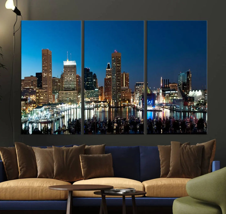 The Baltimore City Lights Night Blue Skyline Wall Art Canvas Print, professionally hand-assembled and ready to hang, graces the wall in this stylish living room.