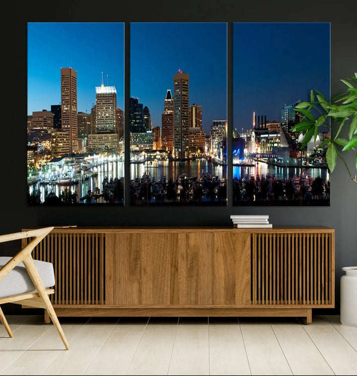 The Baltimore City Lights Night Blue Skyline Wall Art Canvas Print, professionally hand-assembled and ready to hang, graces the wall in this stylish living room.