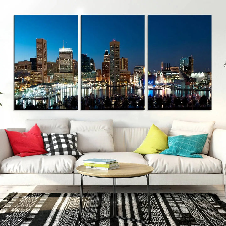 The Baltimore City Lights Night Blue Skyline Wall Art Canvas Print, professionally hand-assembled and ready to hang, graces the wall in this stylish living room.