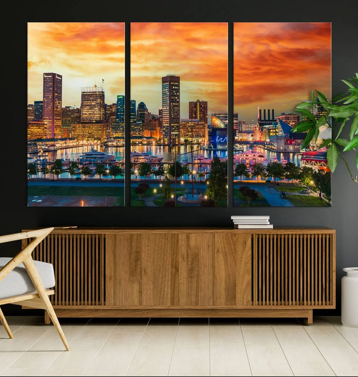 The living room features the Baltimore City Lights Sunset Orange Skyline Cityscape View Wall Art Canvas Print. This vibrant skyline masterpiece is professionally hand-assembled on museum-quality canvases and treated with a UV-protective coating for lasting beauty.