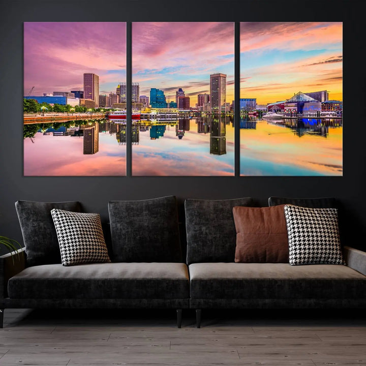 The Baltimore City Lights Sunset Pink and Orange Skyline canvas print depicts a vibrant cityscape at sunset, with skyscrapers reflecting in a calm river on museum-quality canvas. Each piece is gallery wrapped and features a UV-protective coating.