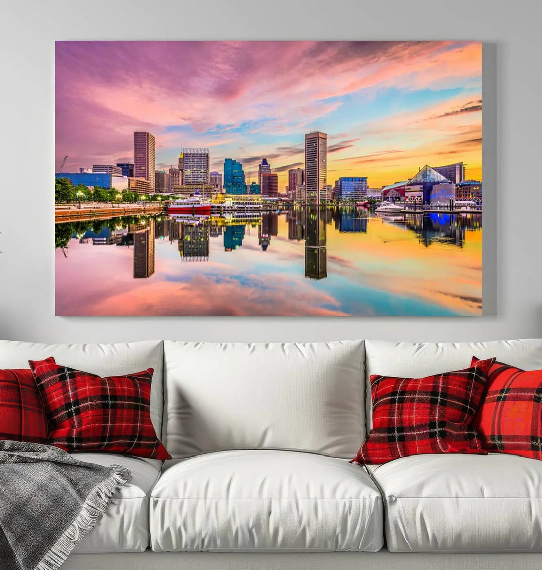 The Baltimore City Lights Sunset Pink and Orange Skyline canvas print depicts a vibrant cityscape at sunset, with skyscrapers reflecting in a calm river on museum-quality canvas. Each piece is gallery wrapped and features a UV-protective coating.