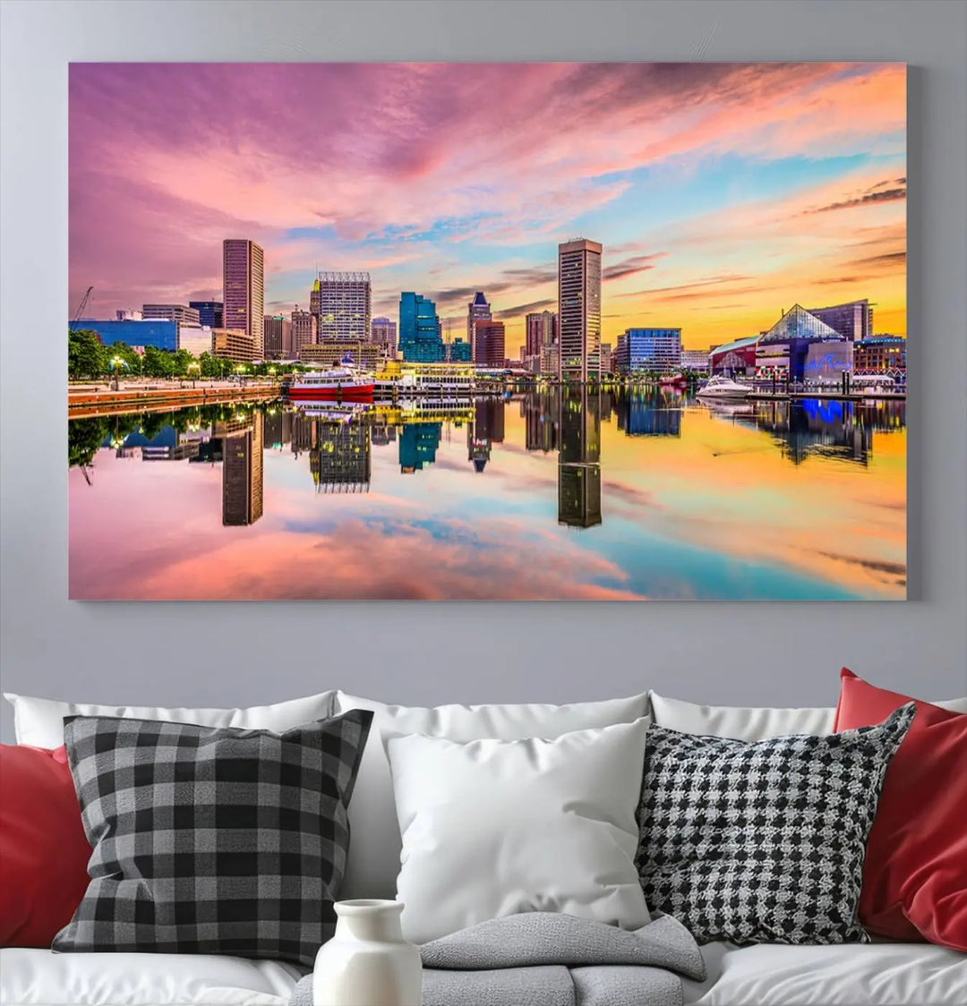 The Baltimore City Lights Sunset Pink and Orange Skyline canvas print depicts a vibrant cityscape at sunset, with skyscrapers reflecting in a calm river on museum-quality canvas. Each piece is gallery wrapped and features a UV-protective coating.