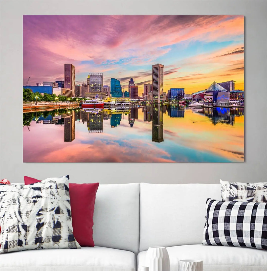 The Baltimore City Lights Sunset Pink and Orange Skyline canvas print depicts a vibrant cityscape at sunset, with skyscrapers reflecting in a calm river on museum-quality canvas. Each piece is gallery wrapped and features a UV-protective coating.