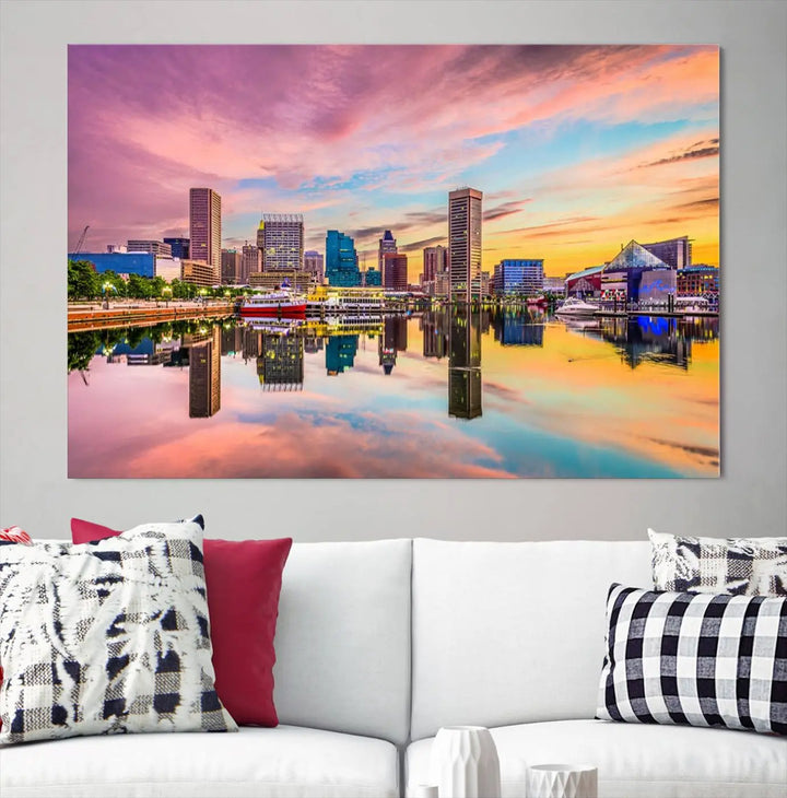 The Baltimore City Lights Sunset Pink and Orange Skyline canvas print depicts a vibrant cityscape at sunset, with skyscrapers reflecting in a calm river on museum-quality canvas. Each piece is gallery wrapped and features a UV-protective coating.