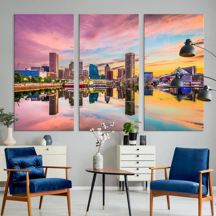 The Baltimore City Lights Sunset Pink and Orange Skyline canvas print depicts a vibrant cityscape at sunset, with skyscrapers reflecting in a calm river on museum-quality canvas. Each piece is gallery wrapped and features a UV-protective coating.