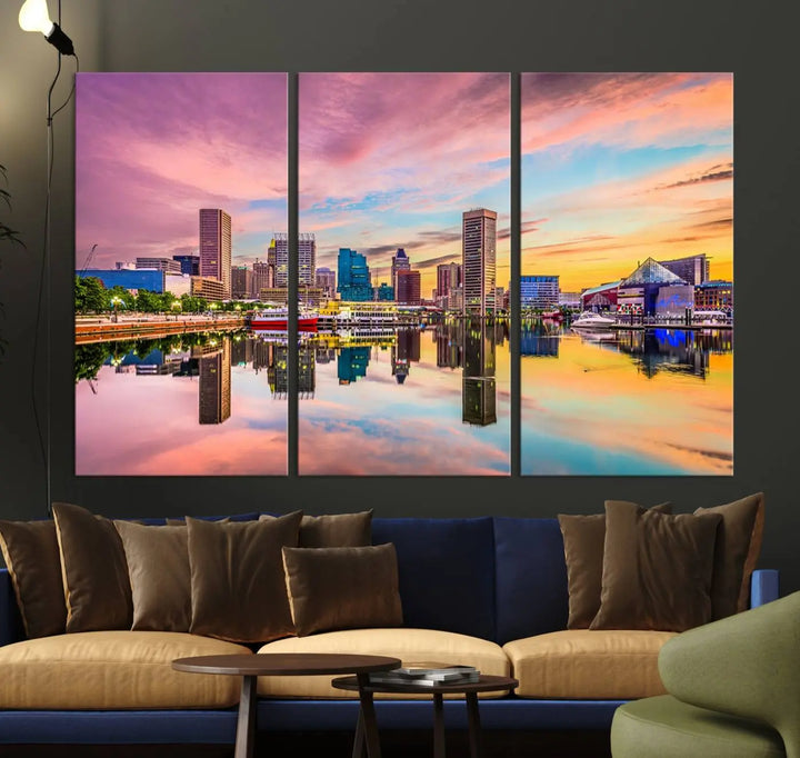 The Baltimore City Lights Sunset Pink and Orange Skyline canvas print depicts a vibrant cityscape at sunset, with skyscrapers reflecting in a calm river on museum-quality canvas. Each piece is gallery wrapped and features a UV-protective coating.