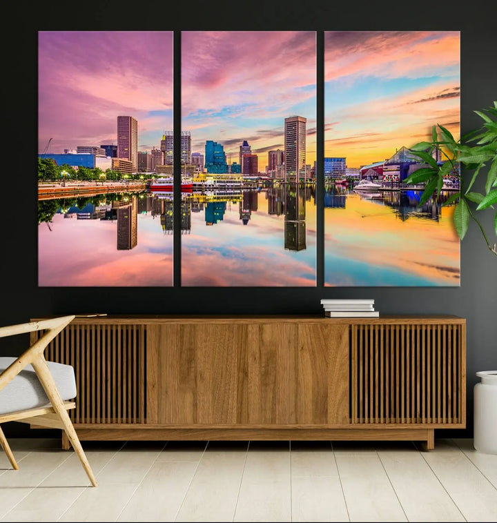 The Baltimore City Lights Sunset Pink and Orange Skyline canvas print depicts a vibrant cityscape at sunset, with skyscrapers reflecting in a calm river on museum-quality canvas. Each piece is gallery wrapped and features a UV-protective coating.