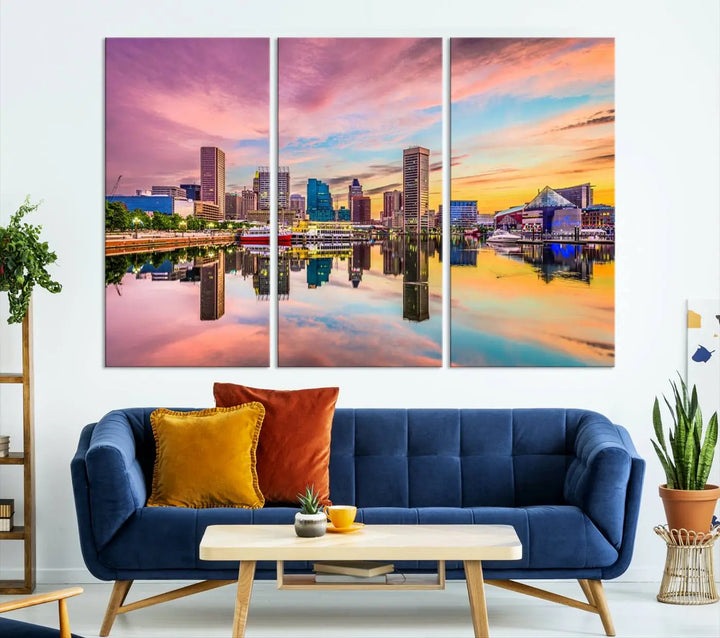 The Baltimore City Lights Sunset Pink and Orange Skyline canvas print depicts a vibrant cityscape at sunset, with skyscrapers reflecting in a calm river on museum-quality canvas. Each piece is gallery wrapped and features a UV-protective coating.