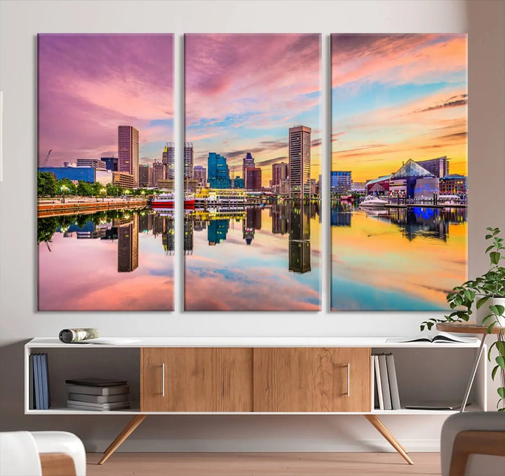 The Baltimore City Lights Sunset Pink and Orange Skyline canvas print depicts a vibrant cityscape at sunset, with skyscrapers reflecting in a calm river on museum-quality canvas. Each piece is gallery wrapped and features a UV-protective coating.