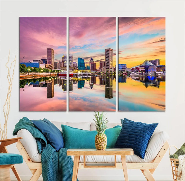 The Baltimore City Lights Sunset Pink and Orange Skyline canvas print depicts a vibrant cityscape at sunset, with skyscrapers reflecting in a calm river on museum-quality canvas. Each piece is gallery wrapped and features a UV-protective coating.