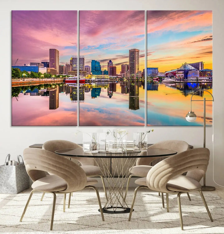 The Baltimore City Lights Sunset Pink and Orange Skyline canvas print depicts a vibrant cityscape at sunset, with skyscrapers reflecting in a calm river on museum-quality canvas. Each piece is gallery wrapped and features a UV-protective coating.