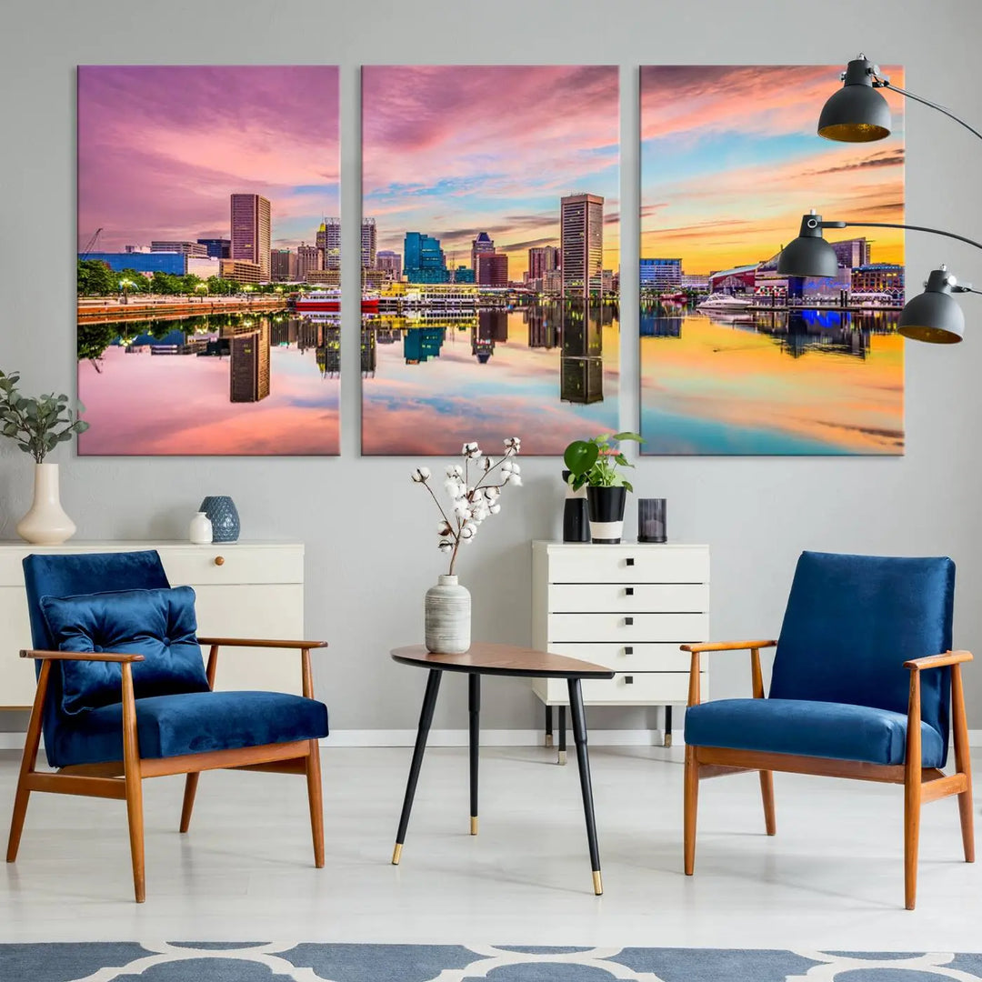 The Baltimore City Lights Sunset Pink and Orange Skyline canvas print depicts a vibrant cityscape at sunset, with skyscrapers reflecting in a calm river on museum-quality canvas. Each piece is gallery wrapped and features a UV-protective coating.