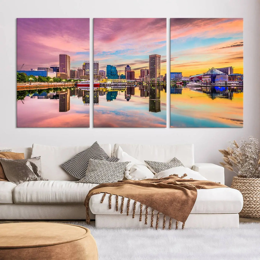 The Baltimore City Lights Sunset Pink and Orange Skyline canvas print depicts a vibrant cityscape at sunset, with skyscrapers reflecting in a calm river on museum-quality canvas. Each piece is gallery wrapped and features a UV-protective coating.