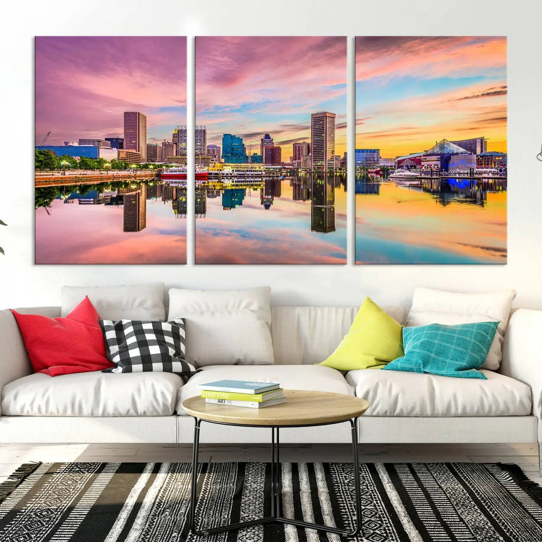 The Baltimore City Lights Sunset Pink and Orange Skyline canvas print depicts a vibrant cityscape at sunset, with skyscrapers reflecting in a calm river on museum-quality canvas. Each piece is gallery wrapped and features a UV-protective coating.