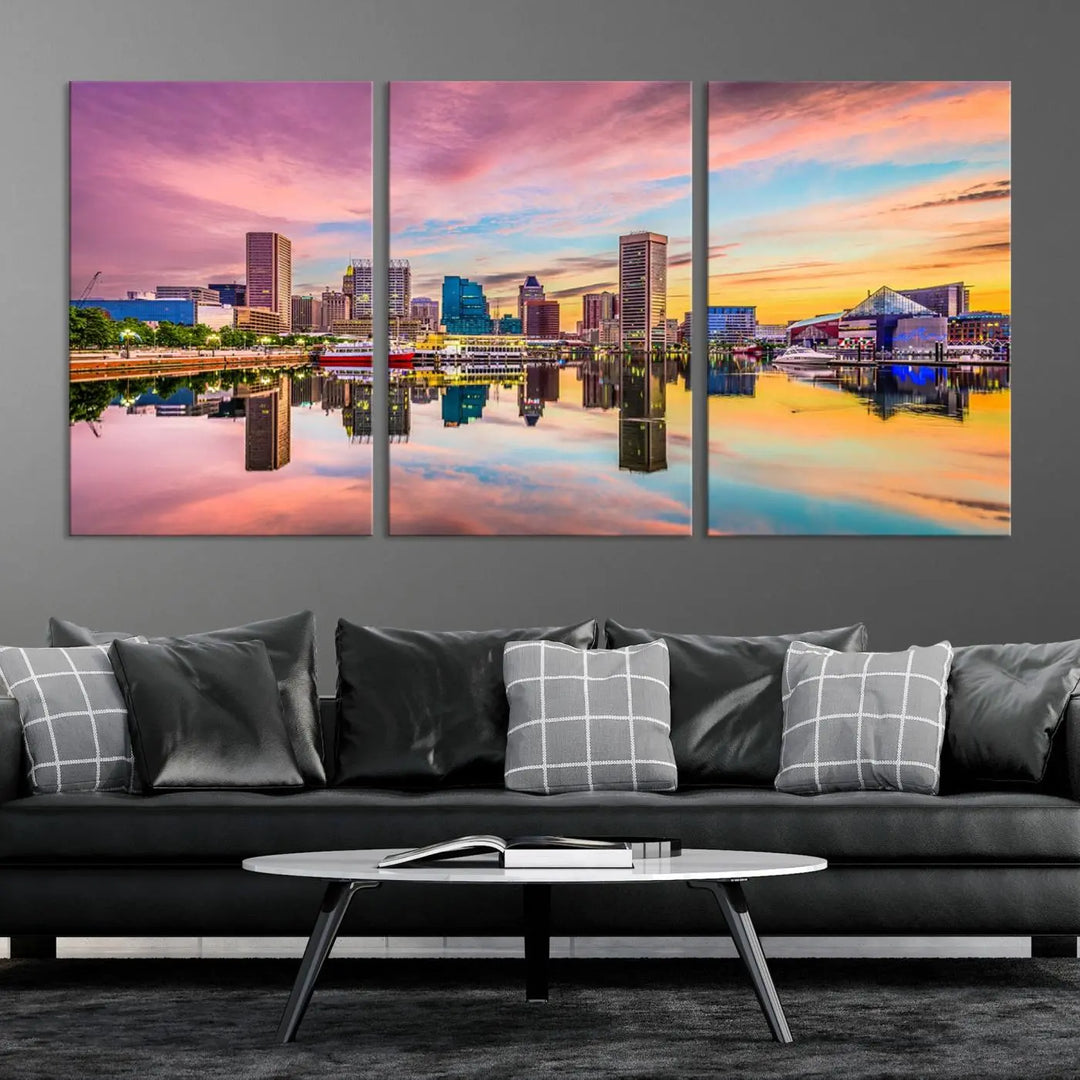 The Baltimore City Lights Sunset Pink and Orange Skyline canvas print depicts a vibrant cityscape at sunset, with skyscrapers reflecting in a calm river on museum-quality canvas. Each piece is gallery wrapped and features a UV-protective coating.