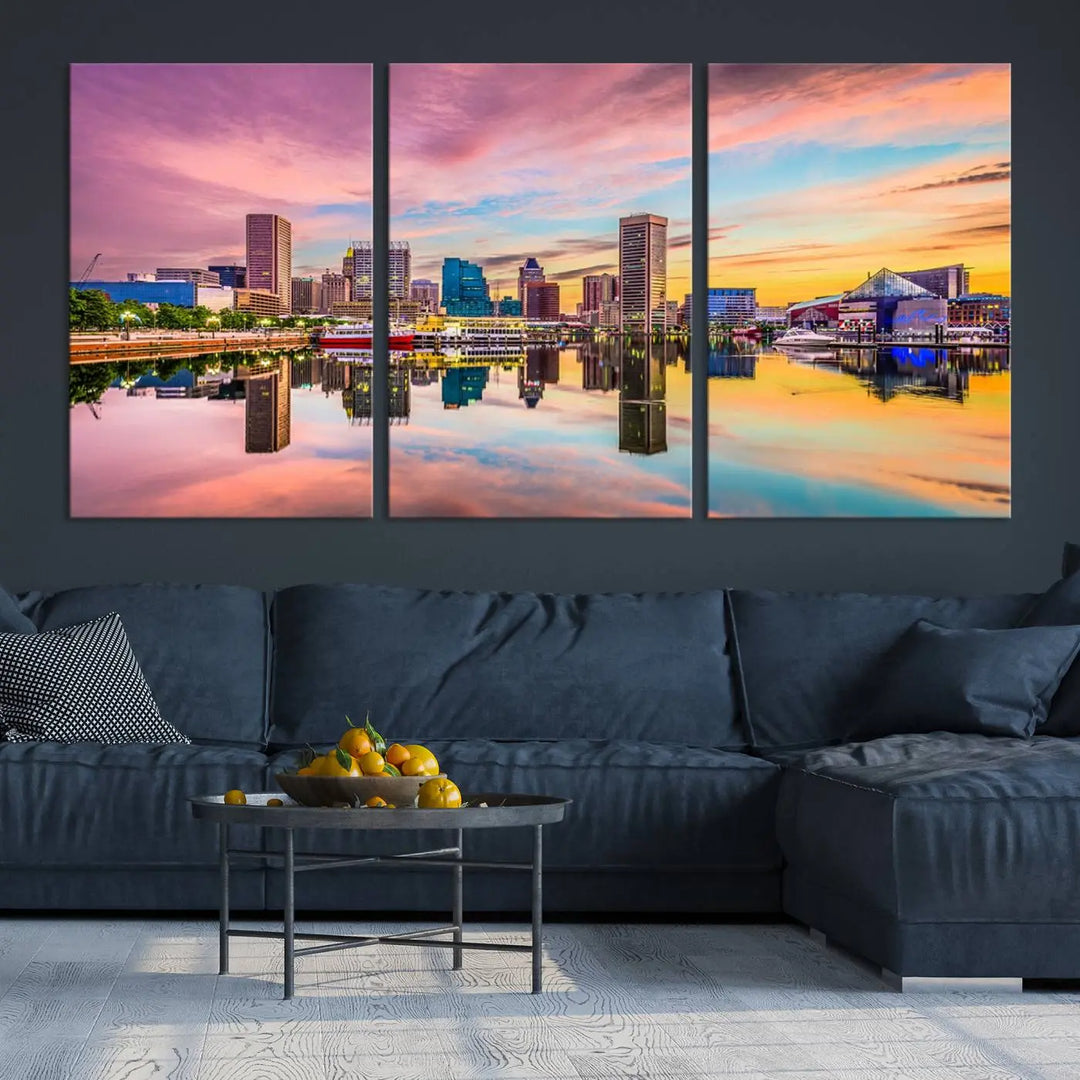 The Baltimore City Lights Sunset Pink and Orange Skyline canvas print depicts a vibrant cityscape at sunset, with skyscrapers reflecting in a calm river on museum-quality canvas. Each piece is gallery wrapped and features a UV-protective coating.