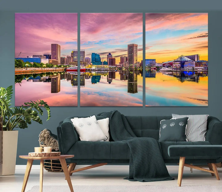 The Baltimore City Lights Sunset Pink and Orange Skyline canvas print depicts a vibrant cityscape at sunset, with skyscrapers reflecting in a calm river on museum-quality canvas. Each piece is gallery wrapped and features a UV-protective coating.