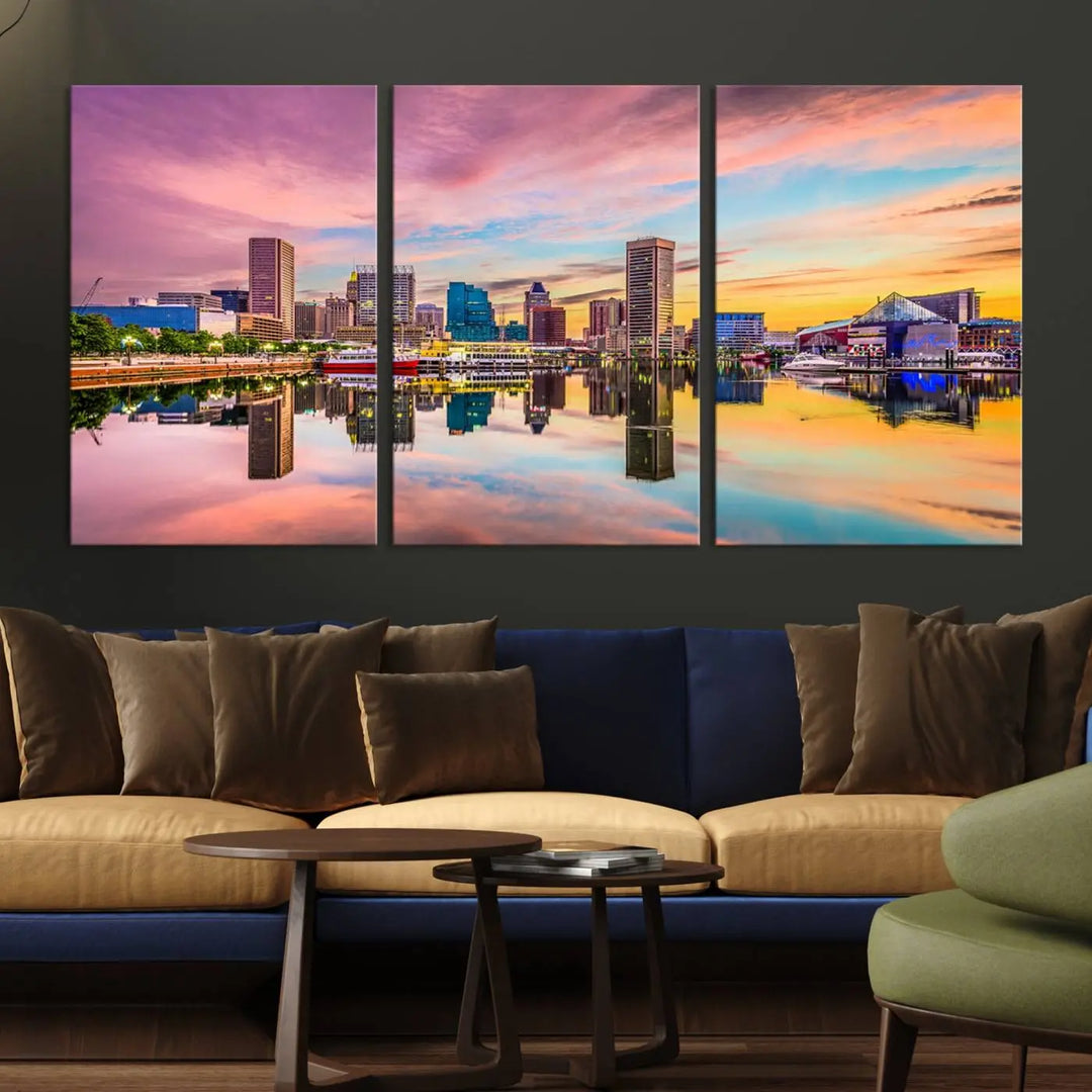 The Baltimore City Lights Sunset Pink and Orange Skyline canvas print depicts a vibrant cityscape at sunset, with skyscrapers reflecting in a calm river on museum-quality canvas. Each piece is gallery wrapped and features a UV-protective coating.