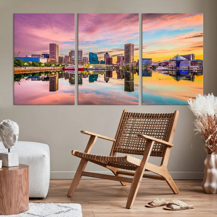 The Baltimore City Lights Sunset Pink and Orange Skyline canvas print depicts a vibrant cityscape at sunset, with skyscrapers reflecting in a calm river on museum-quality canvas. Each piece is gallery wrapped and features a UV-protective coating.