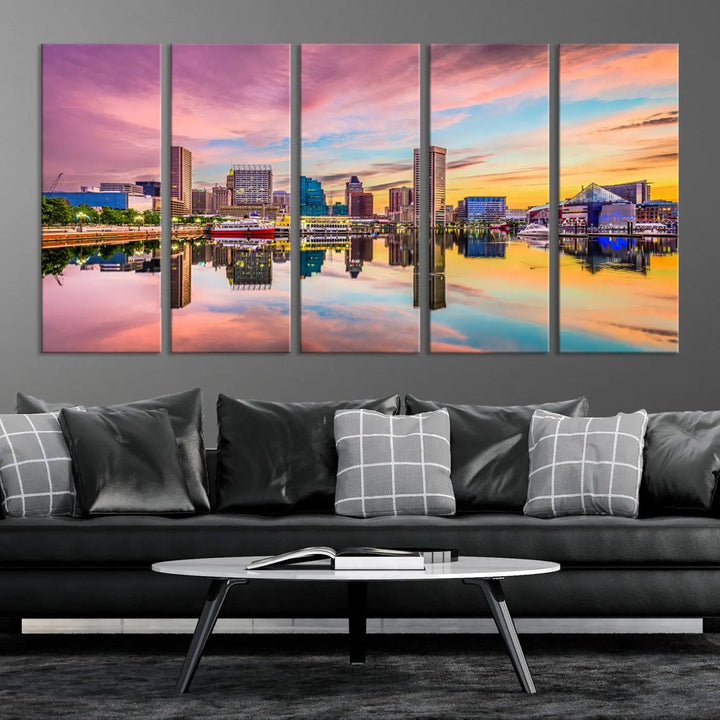 The Baltimore City Lights Sunset Pink and Orange Skyline canvas print depicts a vibrant cityscape at sunset, with skyscrapers reflecting in a calm river on museum-quality canvas. Each piece is gallery wrapped and features a UV-protective coating.