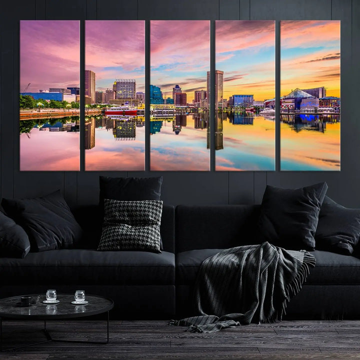 The Baltimore City Lights Sunset Pink and Orange Skyline canvas print depicts a vibrant cityscape at sunset, with skyscrapers reflecting in a calm river on museum-quality canvas. Each piece is gallery wrapped and features a UV-protective coating.