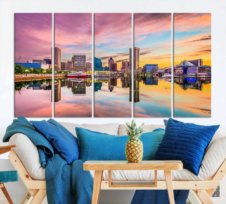 The Baltimore City Lights Sunset Pink and Orange Skyline canvas print depicts a vibrant cityscape at sunset, with skyscrapers reflecting in a calm river on museum-quality canvas. Each piece is gallery wrapped and features a UV-protective coating.