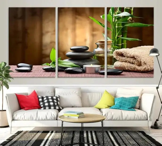 An inspiring Wall Art Canvas Print depicts a tranquil spa scene with Zen Stones and bamboo against the backdrop of a cozy living room.