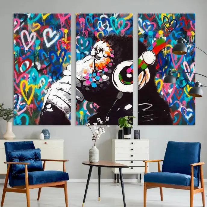 A triptych featuring the "Banksy Canvas Wall Art Thinking Monkey Canvas Art Print" showcases a chimp wearing headphones against a colorful heart-patterned background. Each museum-quality canvas is gallery wrapped and finished with a UV-protective coating to ensure lasting brilliance.