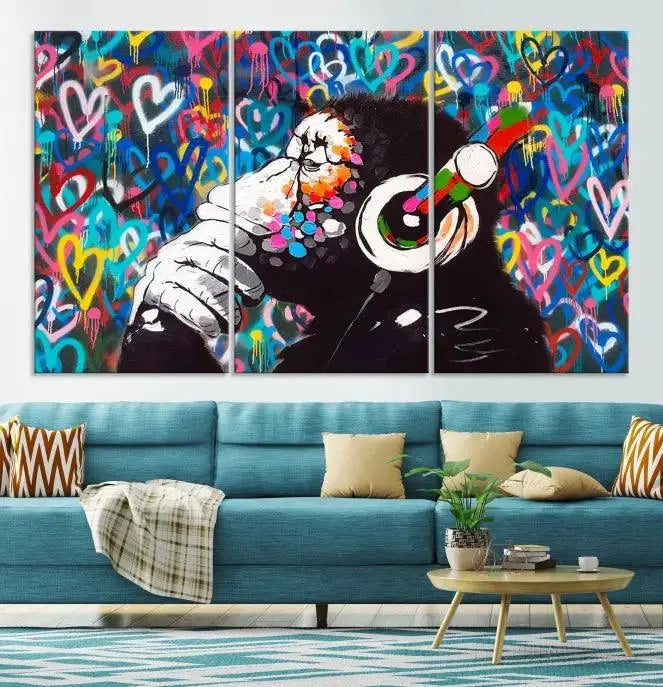 A triptych featuring the "Banksy Canvas Wall Art Thinking Monkey Canvas Art Print" showcases a chimp wearing headphones against a colorful heart-patterned background. Each museum-quality canvas is gallery wrapped and finished with a UV-protective coating to ensure lasting brilliance.