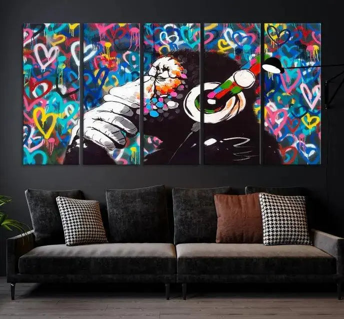 A triptych featuring the "Banksy Canvas Wall Art Thinking Monkey Canvas Art Print" showcases a chimp wearing headphones against a colorful heart-patterned background. Each museum-quality canvas is gallery wrapped and finished with a UV-protective coating to ensure lasting brilliance.