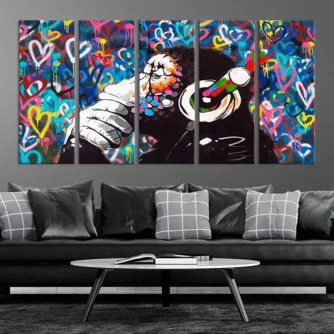 A triptych featuring the "Banksy Canvas Wall Art Thinking Monkey Canvas Art Print" showcases a chimp wearing headphones against a colorful heart-patterned background. Each museum-quality canvas is gallery wrapped and finished with a UV-protective coating to ensure lasting brilliance.