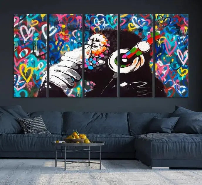 A triptych featuring the "Banksy Canvas Wall Art Thinking Monkey Canvas Art Print" showcases a chimp wearing headphones against a colorful heart-patterned background. Each museum-quality canvas is gallery wrapped and finished with a UV-protective coating to ensure lasting brilliance.