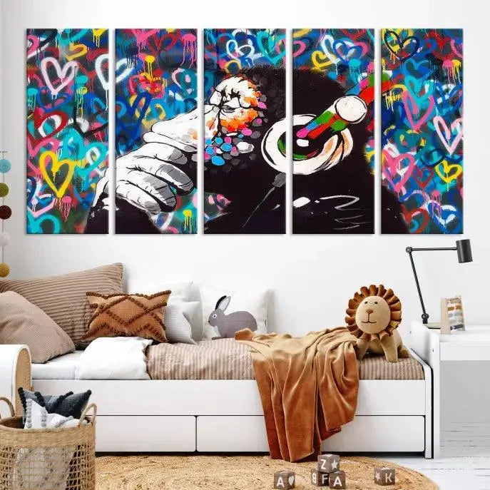 A triptych featuring the "Banksy Canvas Wall Art Thinking Monkey Canvas Art Print" showcases a chimp wearing headphones against a colorful heart-patterned background. Each museum-quality canvas is gallery wrapped and finished with a UV-protective coating to ensure lasting brilliance.