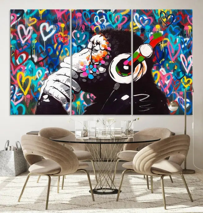 A triptych featuring the "Banksy Canvas Wall Art Thinking Monkey Canvas Art Print" showcases a chimp wearing headphones against a colorful heart-patterned background. Each museum-quality canvas is gallery wrapped and finished with a UV-protective coating to ensure lasting brilliance.