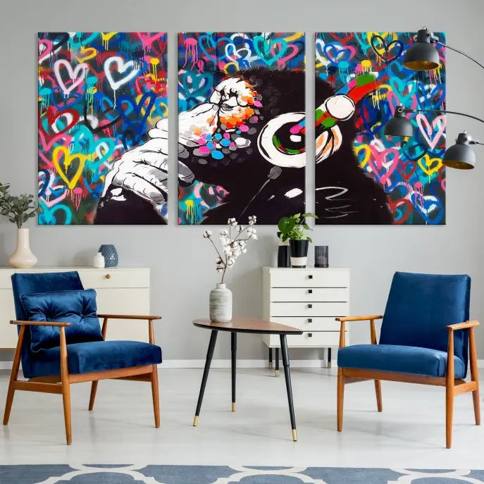 A triptych featuring the "Banksy Canvas Wall Art Thinking Monkey Canvas Art Print" showcases a chimp wearing headphones against a colorful heart-patterned background. Each museum-quality canvas is gallery wrapped and finished with a UV-protective coating to ensure lasting brilliance.