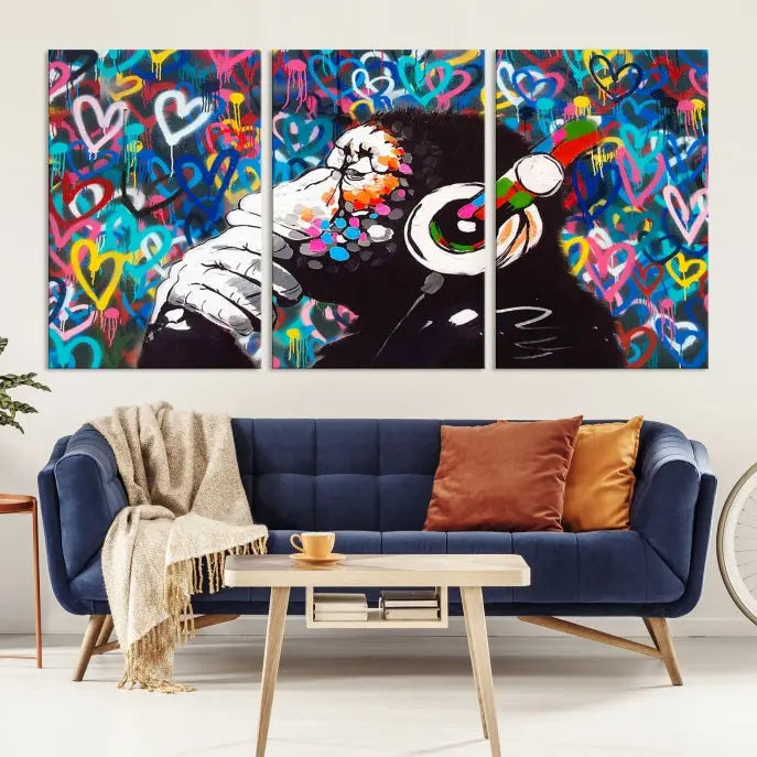 A triptych featuring the "Banksy Canvas Wall Art Thinking Monkey Canvas Art Print" showcases a chimp wearing headphones against a colorful heart-patterned background. Each museum-quality canvas is gallery wrapped and finished with a UV-protective coating to ensure lasting brilliance.