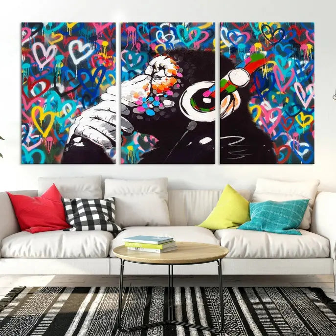 A triptych featuring the "Banksy Canvas Wall Art Thinking Monkey Canvas Art Print" showcases a chimp wearing headphones against a colorful heart-patterned background. Each museum-quality canvas is gallery wrapped and finished with a UV-protective coating to ensure lasting brilliance.