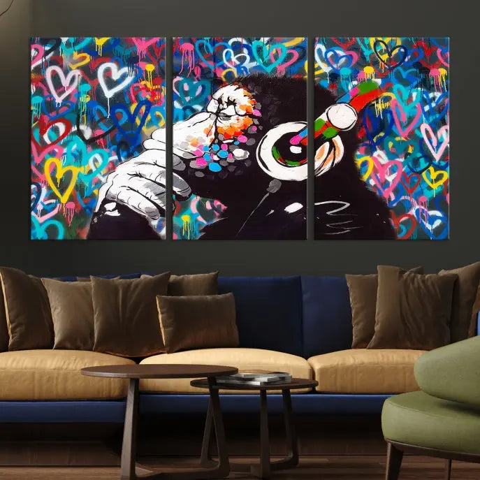 A triptych featuring the "Banksy Canvas Wall Art Thinking Monkey Canvas Art Print" showcases a chimp wearing headphones against a colorful heart-patterned background. Each museum-quality canvas is gallery wrapped and finished with a UV-protective coating to ensure lasting brilliance.