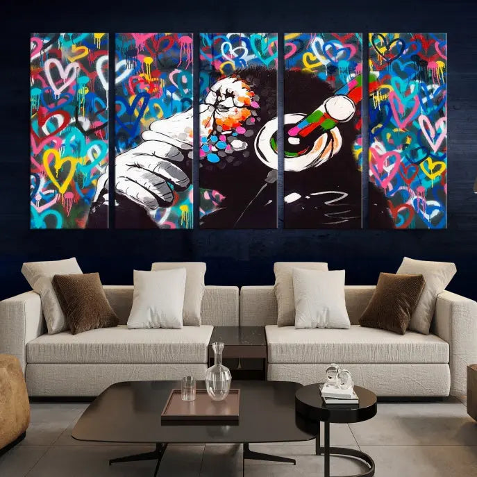 A triptych featuring the "Banksy Canvas Wall Art Thinking Monkey Canvas Art Print" showcases a chimp wearing headphones against a colorful heart-patterned background. Each museum-quality canvas is gallery wrapped and finished with a UV-protective coating to ensure lasting brilliance.