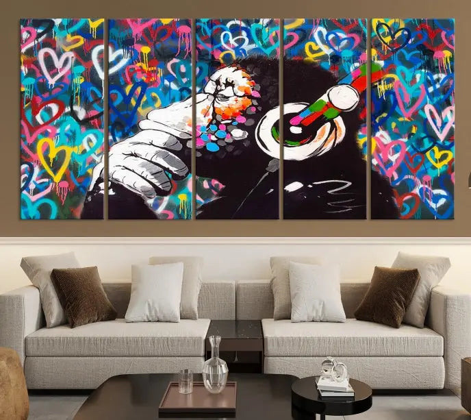 A triptych featuring the "Banksy Canvas Wall Art Thinking Monkey Canvas Art Print" showcases a chimp wearing headphones against a colorful heart-patterned background. Each museum-quality canvas is gallery wrapped and finished with a UV-protective coating to ensure lasting brilliance.