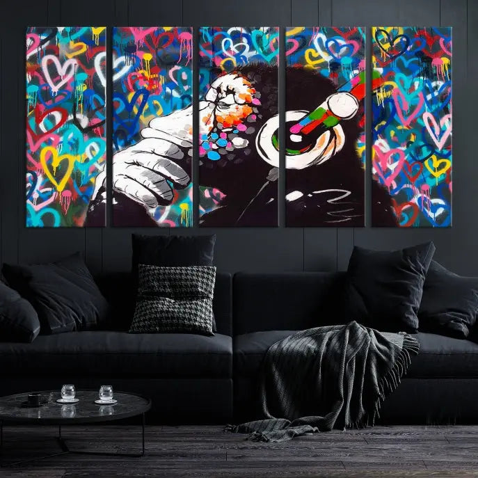 A triptych featuring the "Banksy Canvas Wall Art Thinking Monkey Canvas Art Print" showcases a chimp wearing headphones against a colorful heart-patterned background. Each museum-quality canvas is gallery wrapped and finished with a UV-protective coating to ensure lasting brilliance.