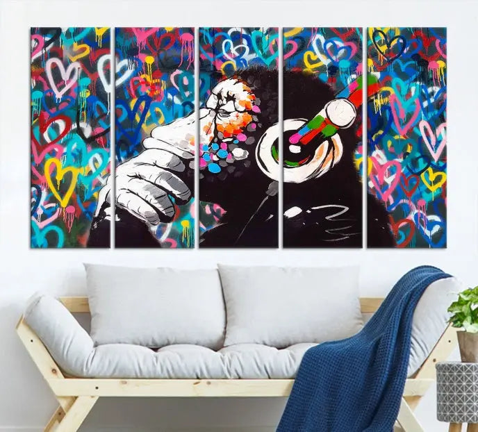 A triptych featuring the "Banksy Canvas Wall Art Thinking Monkey Canvas Art Print" showcases a chimp wearing headphones against a colorful heart-patterned background. Each museum-quality canvas is gallery wrapped and finished with a UV-protective coating to ensure lasting brilliance.